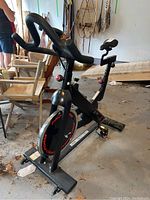 Full view of the black Pro-Form exercise bike with its handlebars, seat, and base with wheels visible.