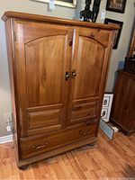 Front view of highboy with doors closed and bottom drawer visible