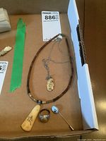 Full jewelry set with pendant necklace, beaded choker, pin, and ring.