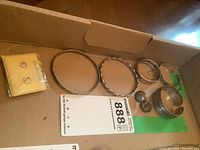 Overview of sterling silver bracelets and earrings arranged in a box on a cardboard surface, showing all items grouped together.