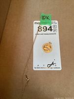 Photo of 10k gold chain and gold charm on MaxSold lot card.