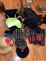 Two 12x16x12 storage boxes and various hats, scarves, gloves, reflective hood and plaid wool blankets.