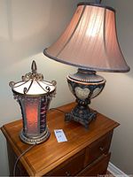 Both table lamps shown side by side on wooden surface, demonstrating size and scale difference.