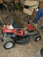 Left side view of mower showing seat, engine cover, cutting deck