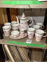 Full set arranged on shelf showing coffee pot, mugs, creamer, sugar bowl and tray