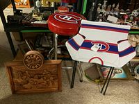 Overview of carved plaque, bar stool, TV tray and DVD case