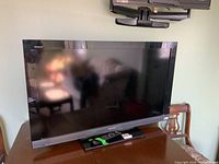 Sony Bravia 40-inch TV on a table with remote control in front of it