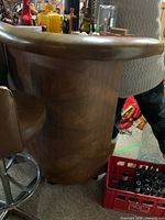 Side view of the wood surface bar showing vinyl padded edge and vertical wood panel base.