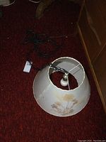 Top angled view of the hanging lamp showing the floral pattern on the Dornbush lampshade, the light bulb socket, and the chain.