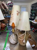 Full view of three pottery lamps, two with Dornbusch shades showing bruises and one smaller without shade.