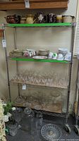 Full view of the metal wire shelving unit stocked with dishes and glassware (not included).