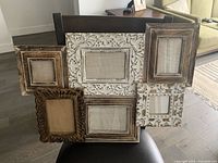 Photo of antique style collage picture frame holding six photo slots on a chair in a home interior.