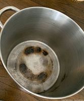 Top view of the inside of the pot showing discoloration and burn marks on bottom and sides