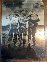 Band of Brothers DVD box set cover with black and white image of soldiers walking arm in arm.
