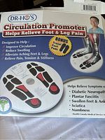 Box showing Dr. Ho's Circulation Promoter branding, usage claims, and bonus travel foot pads.