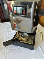 Front angled view of the Gaggia Classic Coffee espresso machine showing stainless steel front panel, portafilter, drip tray and switches.