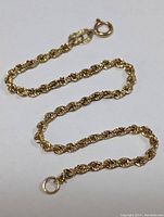 Bracelet laid flat showing full length of rope chain and spring ring clasp