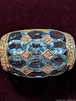 Top view showing nine oval blue topaz stones set in a grid with diamond accent settings