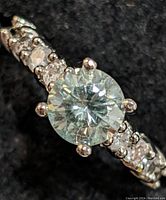 Top view of the ring showing the round lab-grown diamond center and accent diamonds on the band