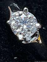 Close-up of diamond face showing round brilliant cut and prong setting