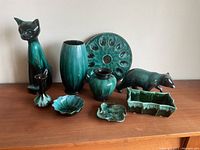 Front view of the full set showing all eight pieces arranged on table against wall.