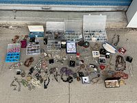 Overview of lot showing necklaces, bracelets, earrings, brooches and compartment boxes