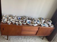 Full sideboard view of entire spread of dinnerware and serveware
