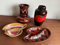 Full view of set showing two ceramic vases and three ashtrays in various shapes and colors
