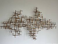 Front view of full wall sculpture mounted on a white wall