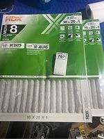 Two unopened packs of HDX furnace air filters in original green packaging, each containing 3 pleated filters sized 16x20x1 inches with MERV 8 rating.