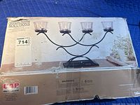 Box displaying Simply Home Solutions branding and candle stand image.