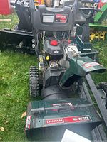 Front view showing clearing chute, intake housing, discharge chute and Craftsman badge