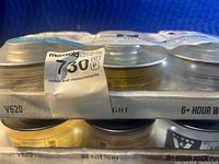 Two packs of Leo Light wick fuel canisters in original packaging, six cans per box, total twelve cans. Close-up shows label indicating 6+ hour burn time and safety information.