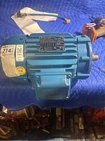 Blue WEG electric motor with visible nameplate and stickers.