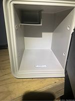 Interior of Sentry Group fire safe showing light gray compartment with a small upper shelf.