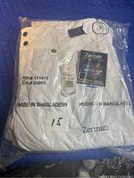 Zermatt women's white snow pants size Large in original sealed packaging with RN and CA numbers visible and size marked on the package.