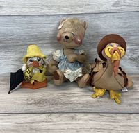 Front view of three plush toys showing duck, bear, and turkey figures.