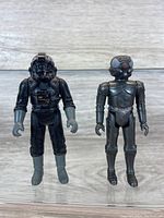 Front view of two Star Wars action figures, a TIE Fighter Pilot and a 2-1B Medical Droid.