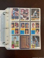 Page of 1984 Topps baseball cards in plastic sleeve, showing multiple player cards with colorful border and front text