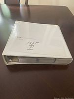 Closed white three-ring binder labeled '1985 D' containing the baseball cards.