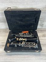 Bundy clarinet disassembled and housed inside the original black hard case with velvet lining and cleaning brush.