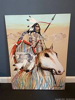 Full view of the large canvas painting showing the Native American on horse with spear and bison motif.