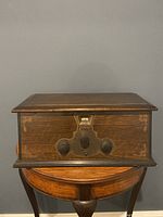 Full front view of wooden Standardyne radio cabinet showing shape and condition