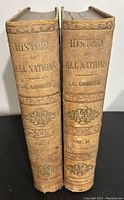 Two volumes with gilt lettered spines reading 'History of All Nations S.G. Goodrich Vol I' and 'Vol II.' Spine and edge wear visible.