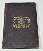 Front cover of book with decorative embossed brown leather and gold embossed title.