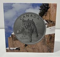 Obverse of the 2014 Canada $20 silver bobcat coin displayed with a background image.