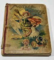 Front cover of the antique Mother Goose book showing illustration and publisher name.