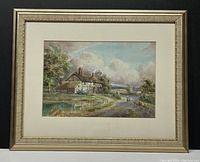 Full view of the framed watercolour painting depicting a rural cottage scene with sky and distant landscape, showing frame and matting.