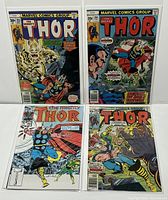 Four comic books from The Mighty Thor series, bagged and boarded, laid flat to show front covers.