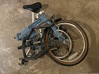 Bike folded, showing compact shape and wheel alignment